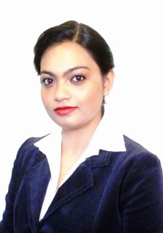 Dr. Madhuleena Dasgupta writing at her desk by a window